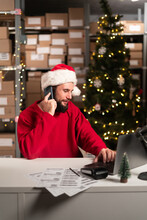Happy Man In Front Laptop Computer Pick Up Phone Purchase Order Stock Detail Customer Online Data Delivery At Warehouse. Startup Small Business Concept. Christmas Sale