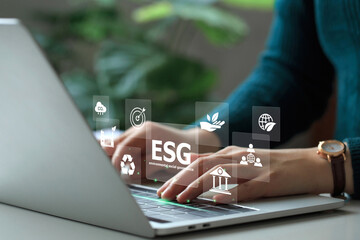 ESG environmental social governance investment business concept. Woman working on laptop computers with ESG icons surround. Concept of Investment strategy for Business and environmental sustainability