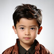 A demure 7-year-old Kazakhstani boy with a modest expression in a professional studio headshot.