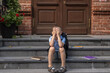 © Mikhail - Upset boy sitting at school and covered his face with his hands. School books are strewn on the steps next to him