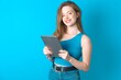 © Roquillo - Photo of optimistic Young beautiful girl wearing blue T-shirt hold tablet