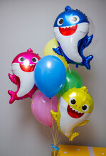 A Big Yellow Box With Balloons, A Set Of Balloons Baby Sharks