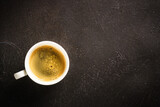 Fototapeta Mapy - Coffee cup. espresso in white cup at dark table. Top view image.