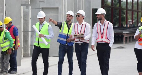 Wall Mural - Ethnic diversity worker people. Success teamwork. Group of professional Construction engineering people wearing hardhat safety helmet meeting at Prefabricated concrete walls Industry 