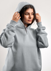 Canvas Print - Young Girl Wearing a Logo-Free Hoodie. Modern Brand Presentation Mock-up.