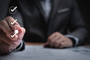 Fototapete - Businessman using pen to tick correct sign mark in checkbox for quality document control checklist ,document approve and business approve project concept.