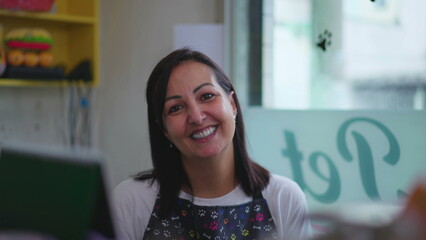 Wall Mural - Portrait of a happy female Entrepreneur owner of small business behind counter wearing apron