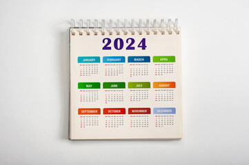 Calendar Year 2024 schedule. colorful 2024 desk calender notepad on light gray background. Resolution, strategy, solution, goal, business and New Year holiday