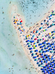 Wall Mural - top view from drone at beach and azure sea. aerial view on beach, people and umbrellas. europe, medi