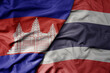 © luzitanija - big waving realistic national colorful flag of cambodia and national flag of thailand .