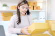 © mangpor2004 - Young asian woman selling online taking orders with smartphone for online shopping business , Asia female entrepreneur working at home