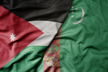 big waving realistic national colorful flag of jordan and national flag of turkmenistan .