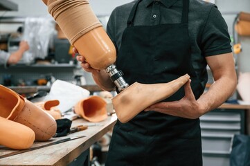 Close up view. Technician holding prosthesis in hands