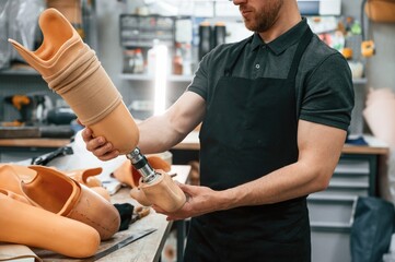 Close up view. Technician holding prosthesis in hands