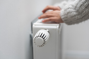 Children's hands warm on the radiator.