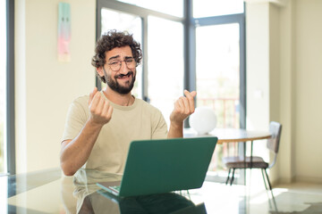 Sticker - young adult bearded man with a laptop feeling sad and stressed, no money gesture, with a negative and anxious look