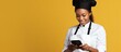 © HN Works - African American cook uses smartphone while cooking
