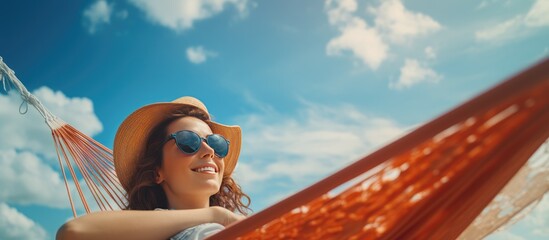 Poster - Blue sky beach relaxation holiday concept with woman in hammock