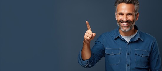 Poster - Smiling middle aged man pointing happily with both hands showing object in empty area