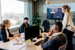 © Maskot - Happy business colleagues discussing with each other in conference room at office