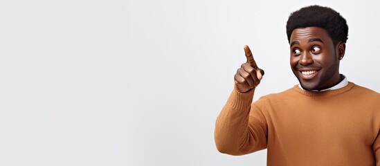 Sticker - Happy African man gesturing at blank area isolated on white