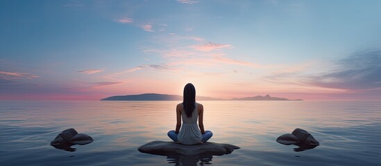 Leinwandbilder - Rear view of woman by the sea embodying meditation and healthy lifestyle