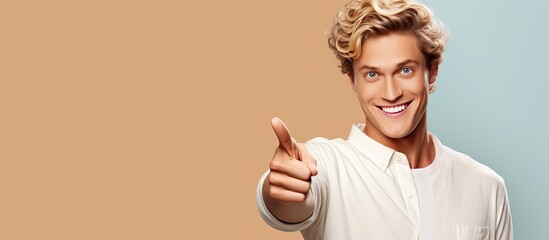 Poster - Happy and satisfied young man casually pointing to empty space with a cheerful smile