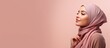 © HN Works - Curious Muslim woman in headscarf interested Arab female wearing hijab pink studio background with copy space