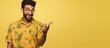 © HN Works - A Latin man in a printed shirt over a yellow background points and advertises suggesting the best price available