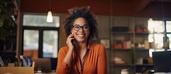Plus size African American woman chatting on phone in office space for text