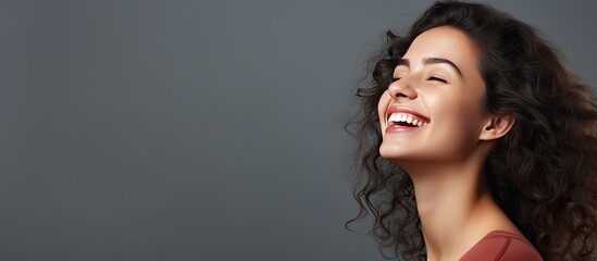 Poster - Closeup portrait of a happy woman laughing at a joke gesturing and reacting to a compliment or remark with grey background for adding text