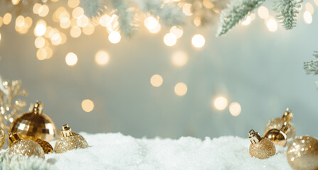 Wall Mural - christmas holiday background with snow, fir tree and decorations with christmas light behind