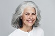 © Andrii Zastrozhnov - A stylish and elegant mature woman in a white shirt laughs with joy.