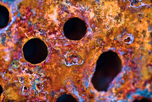 The Surface Of Rusty Iron With Drilled Holes For Bolts. Ultra Macro Background