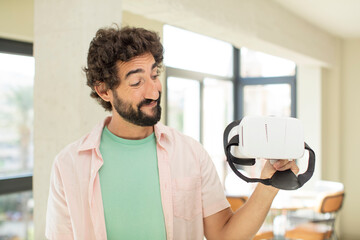 Wall Mural - crazy bearded man smiling and looking with a happy confident expression. vr goggles concept