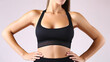 © Gasspoll - Close up shot of unrecognizable fit woman wearing blank tank top & yoga pants. Torso of slim attractive female with six pack belly in sportswear. Copy space for text. Generative AI