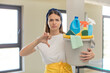 © kues1 - young pretty woman feeling cross,showing thumbs down. clean products and housekeeping concept