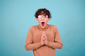 Wall Mural - Funny curly guy with different emotions posing in the studio.