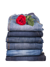 Jeans Clothes Are Put By A Pile And A Red Rose
