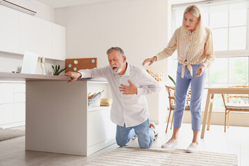 Sticker - Mature woman and her husband having heart attack in kitchen