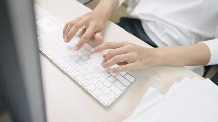 close up hand of a business woman typing keyboard with hands and fingers desktop computer on desk office,online messaging and online marketing business concept.
