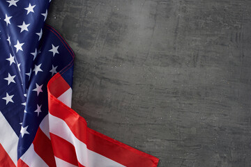 Wall Mural - Connecting with the collective spirit of national Labor Day. Top view arrangement of national USA flag on concrete grey background with blank space for promo or text