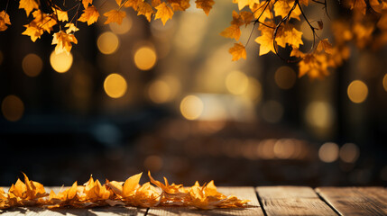 Yellow maple leaves on wooden table in garden at autumn