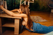 © andrey - a naked woman in denim jumpsuit lying on the floor near the coffee table