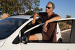 © Marcos - Mature Man taking a break from driving and relaxing and leaning on his car door