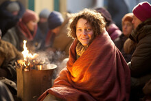 Positive Homeless Woman Sits On The Street Near The Bonfire, Surrounded By Other Individuals