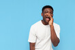 © Богдан Маліцький - african american man shouting and saying message on blue isolated background, guy announcing secret