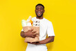 © Богдан Маліцький - joyful male african american shopper holding eco bag with groceries and smiling