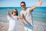 Fototapeta Uliczki - Little girl and happy dad having fun during beach vacation