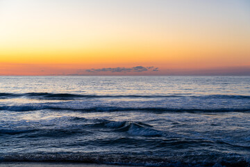 Wall Mural - Sunrise on Hatteras Island with Small Waves Breaking on the Beach From the Ocean